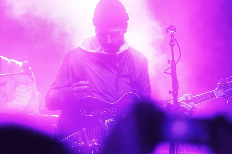 Concert guitarist in purple fog